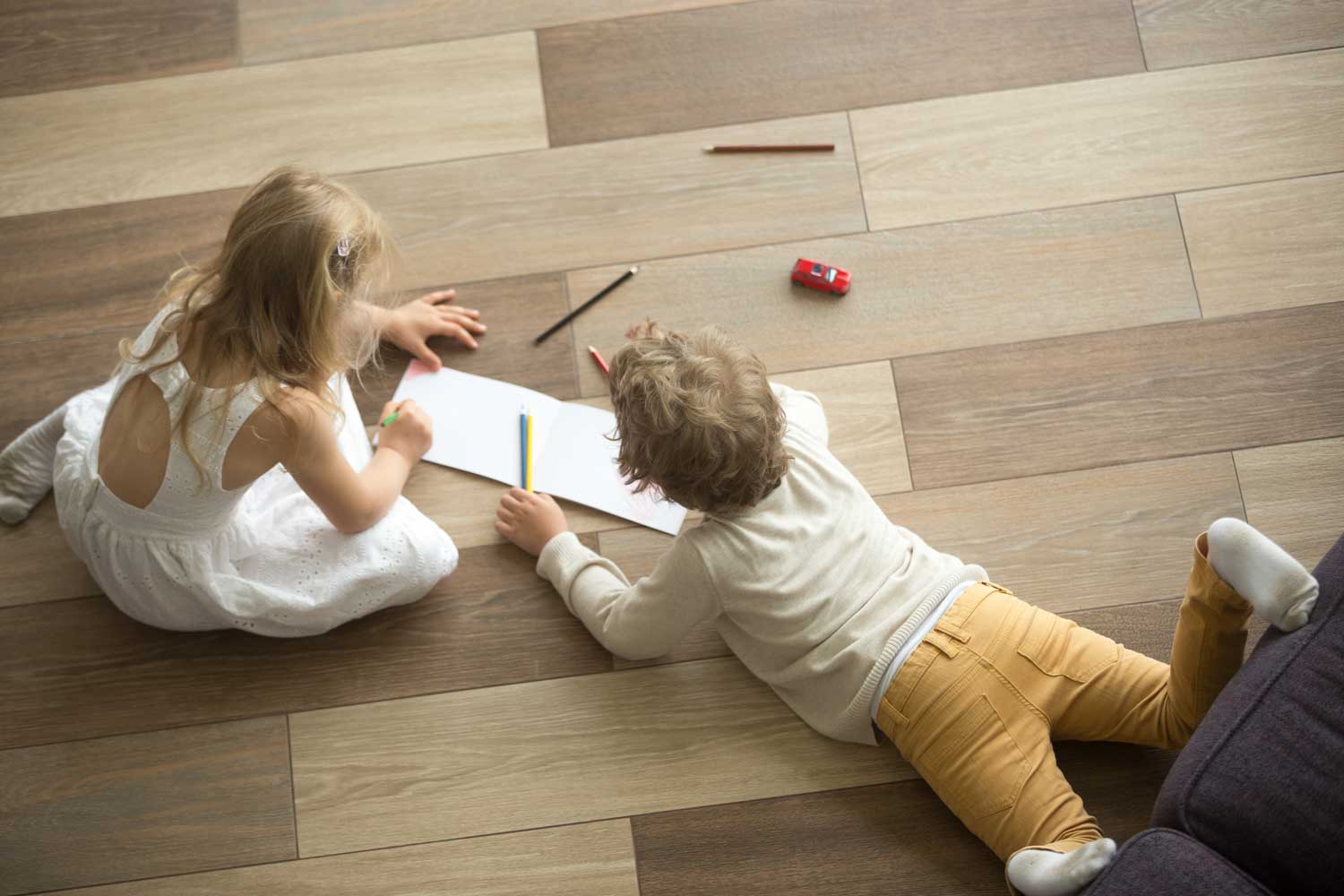 A picture of two children playing on the vinyl flooring - Footprints Floors.